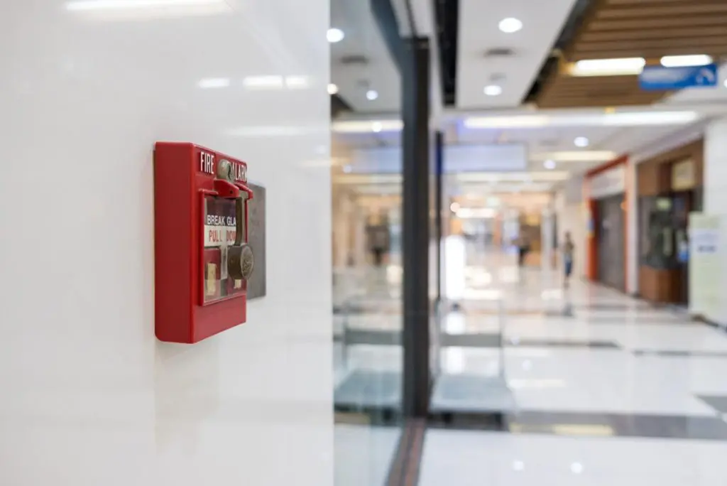 Commercial fire alarm system installed on office wall for 24/7 monitoring