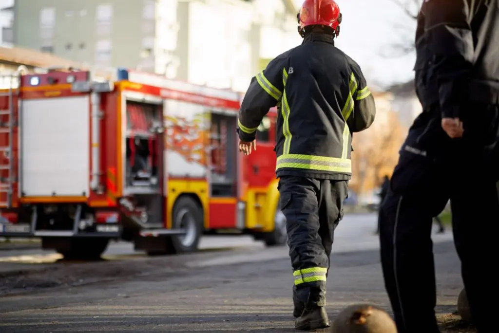 Emergency fire response team arriving after monitored fire alarm activation