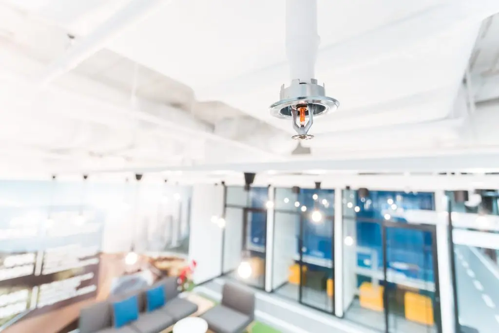 Industrial fire sprinkler system activated to suppress building fire