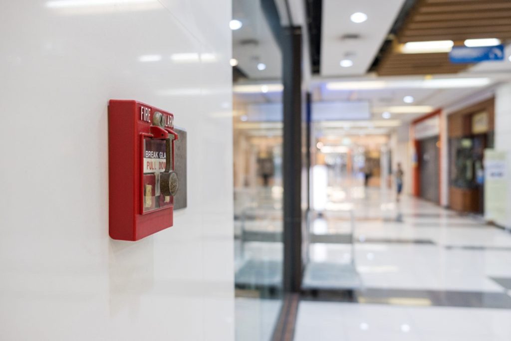 Commercial fire alarm system installed on office wall for 24/7 monitoring