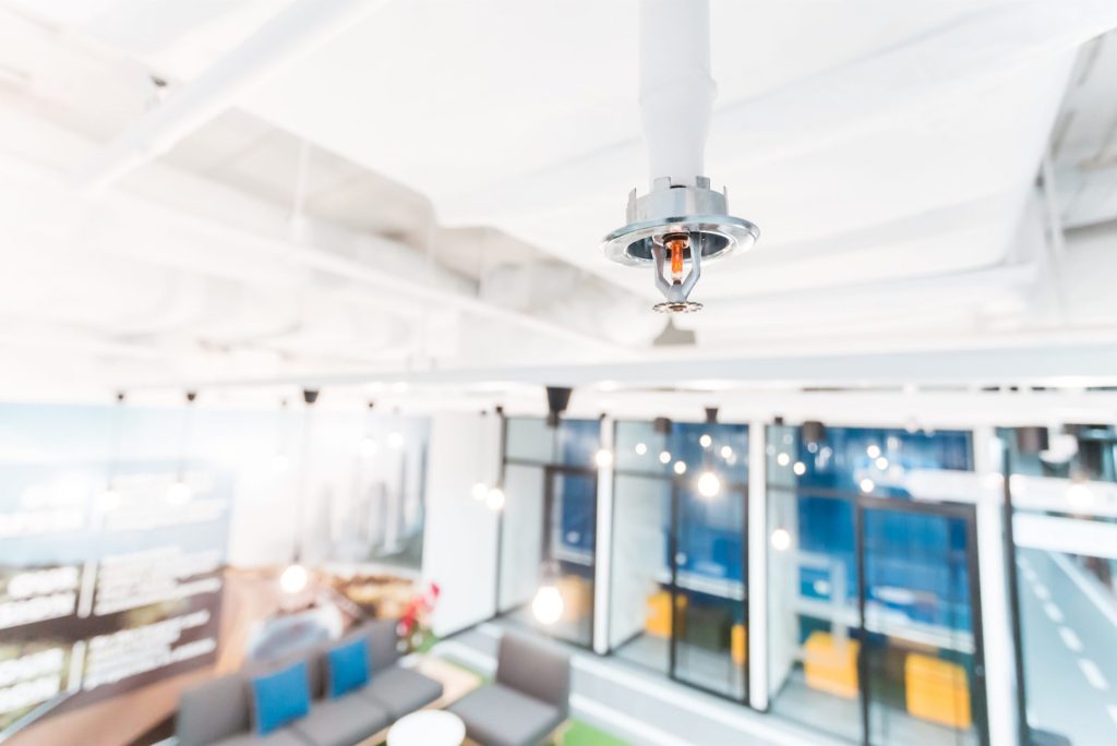 Industrial fire sprinkler system activated to suppress building fire